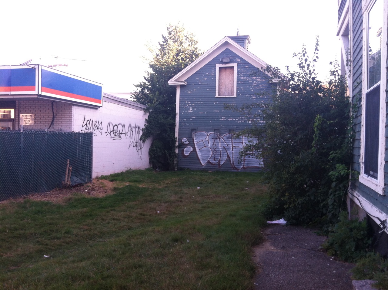 Graffiti mars Cumberland Farms and carriage house at the Hill-Lassonde House.