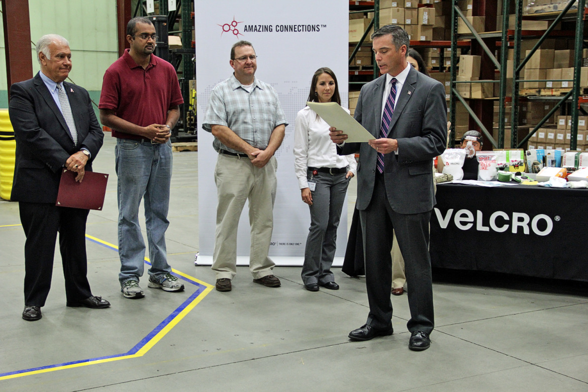 MANCHESTER, NH – New Hampshire joined the rest of the nation in celebrating Manufacturing Day on Friday, concluding a week of events highlighting the importance and opportunities in state’s top industry with a ceremony at Velcro USA.   “Thank you for joining us today to recognize New Hampshire’s rich manufacturing heritage and celebrate its vibrant future,” Velcro USA New Hampshire Operations Manager Donald Boulanger told the gathering, which included Manchester Mayor Ted Gatsas and state Sens. Lou D’Allesandro and Donna Soucy.   While all 50 states recognize Manufacturing Day, New Hampshire is the only one that’s declared Manufacturing Week. In its second year, New Hampshire Manufacturing Week organizers connected 41 companies across the state with over 1,000 high school students and their teachers touring their plants to see what happens in this industry that is an important driver of the state’s economy. In addition, about 500 people took part in tours and open houses hosted by the state’s community colleges and career-technical education centers.   “Velcro USA is honored to host today’s recognition ceremony,” Boulanger said. “We have been a part of New Hampshire’s manufacturing community for nearly 60 years and are committed to its growth and evolution. This week, we hosted groups of students for tours of our facility here. We’re helping to inspire and encourage the next generation of manufacturing leaders by showing them that today’s manufacturing operations are driven by technology and innovation, provide strong career opportunities and, most importantly, help to grow the New Hampshire economy.”   Department of Resources and Economic Development Commissioner Jeffrey Rose read a proclamation issued by Gov. Maggie Hassan, declaring Manufacturing Week. He noted that manufacturing in the state employs over 66,000 people.   “It’s important that we have an event like this every year because it elevates the profile of the state’s largest industries,” Rose said.   Gatsas also presented Velcro USA with a resolution honoring Manufacturing Day and the city’s rich heritage of manufacturing.   Cutlines: Commissioner Rose reads a proclamation from Gov. Maggie Hassan declaring Sept. 29-Oct.3 as Manufacturing Week in New Hampshire. The Granite State joined the rest of the nation on Friday (Oct. 3) to mark Manufacturing Day.     Velcro USA New Hampshire Operations Manager Donald Boulanger welcomes state and local dignitaries to the Manchester facility on Manufacturing Day on Friday (Oct. 3), which capped a week long series of events focusing on the state’s advanced manufacturing industry and the opportunities available to young people. Also pictured are Department of Resources and Economic Development Commissioner Jeffrey Rose and state Sens. Donna Soucy and Lou D’Allesandro.