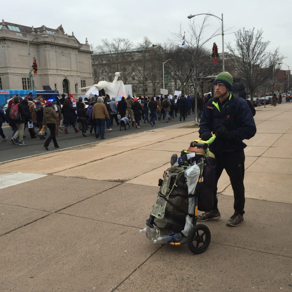Greg Hindy in Hartford, Ct. on Dec. 21, passing a group of protestors.