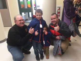 Jeff Duval, left, and Brendan Burns, right, with the Barrette boys, recipients of new winter coats through Operation Warm.