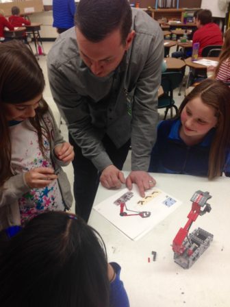 FIRST Junior STEAM Ahead mentor Griffin LaFleur of SilverTech working with fourth graders at Green Acres Elementary School. 