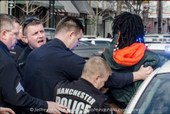 Police attempt to handcuff ; Lovensky Jonick Maschabaz-Mesidor, who faces several charges.