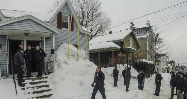 City officials investigate a complaint of an illegal rooming house on Lowell Street.