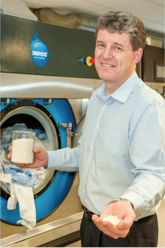 Dr. Steve Jenkins, Xeros chief science officer, with the tiny little polymer beads.
