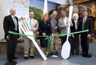 From left: NH Department Of Transportation Turnpikes Administrator Chris Waszczuk, New Hampshire Liquor Commissioner Chairman Joseph Mollica, Governor Maggie Hassan, Alex Ray of Common Man restaurants and Granite State Hospitality, Rusty McLear of Mill Falls at the Lake in Meredith & Granite State Hospitality, Ray Burton’s sister Joan Day, NH Department of Resources and Economic Development Commissioner Jeff Rose.