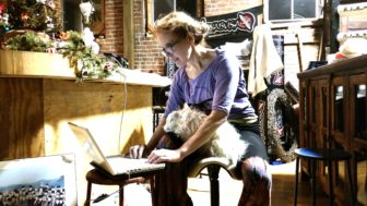 Linda Murphy  working after hours at Murphy's Gym with her dog, Leeloo.