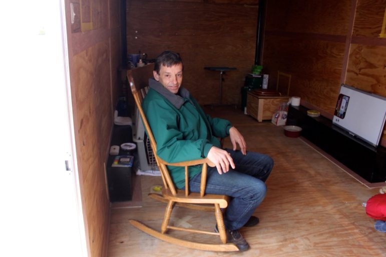 Keith Howard makes himself at home inside NH's first 'Liberty Home,' a 170-square-foot cargo trailer.