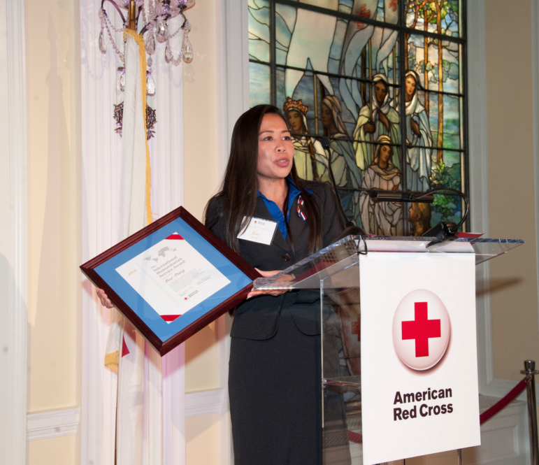 Red Cross Services volunteer Bao Dang accepts the 2013 International Humanitarian Award in Washington, D.C. 