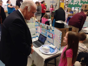 Mayor Ted Gatsas learns a thing or two about natural habitat from a Gossler Park student.