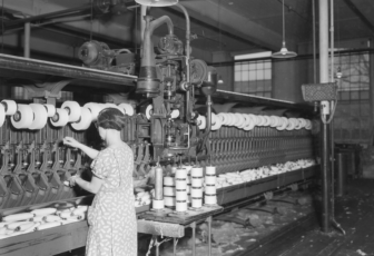 Pacific Mills. Woman does work of 4 with hand-tying machine.  1937