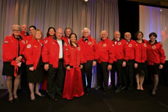 City Year NH “Bridge Builder” Award winners, donning their gifts of City Year “Red Jackets,” left to right: Lesa Scott, Alderman Daniel O’Neil, Stefany Shaheen (accepting for Senator Jeanne Shaheen), Dr. Debra Livingston, Senator Kelly Ayotte (accepting for Senator Judd and Kathy Gregg, Larry Klane, Stephen Gianotti, Pawn Nitichan – City Year NH Executive Director, Patrick Duffy, Mayor Ted Gatsas, Lewis Feldstein, Major General (Ret.) Kenneth Clark, Alexandra Allen – City Year Regional VP, and Kerri St. Jean.