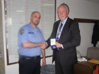Corrections Officer Peter Ash receives commendation from NH Dept. of Corrections Commissioner, William Wrenn.