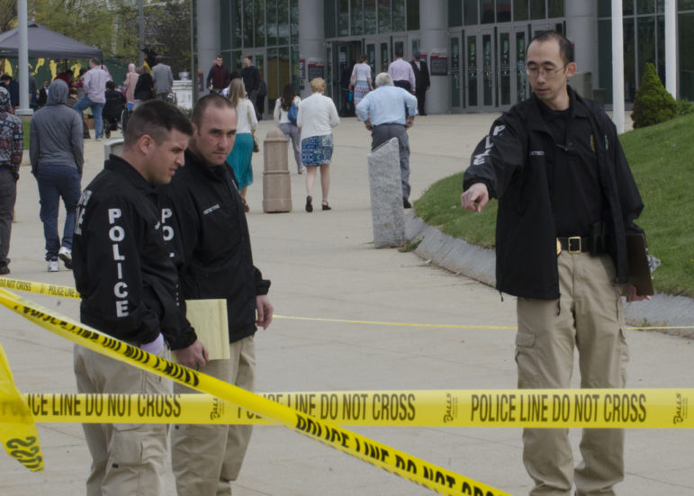 Manchester Police detectives investigate the crime scene outside of the Verizon Wireless Arena.