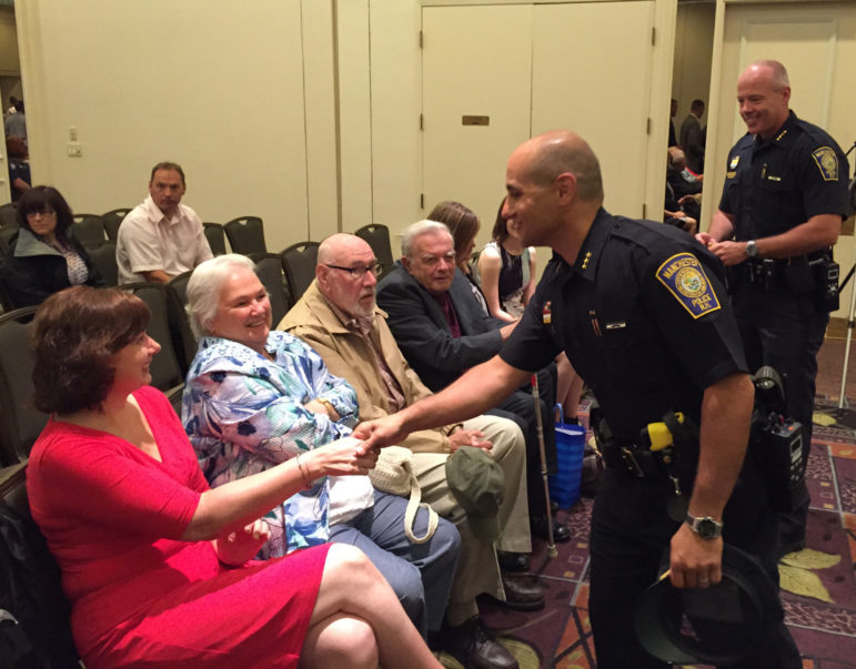 Asst. Chief Carlo Capano greets Diane Willard, wife of the new Chief.