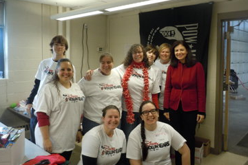 U.S. Sen. Kelly Ayotte, R-NH,  right, pictured at a Nov. 2014 packaging event for Mooremart.