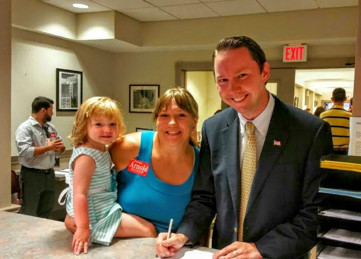 Mayoral candidate Patrick Arnold files his paperwork at City Hall with wife Kathy and daughter, Abigail.