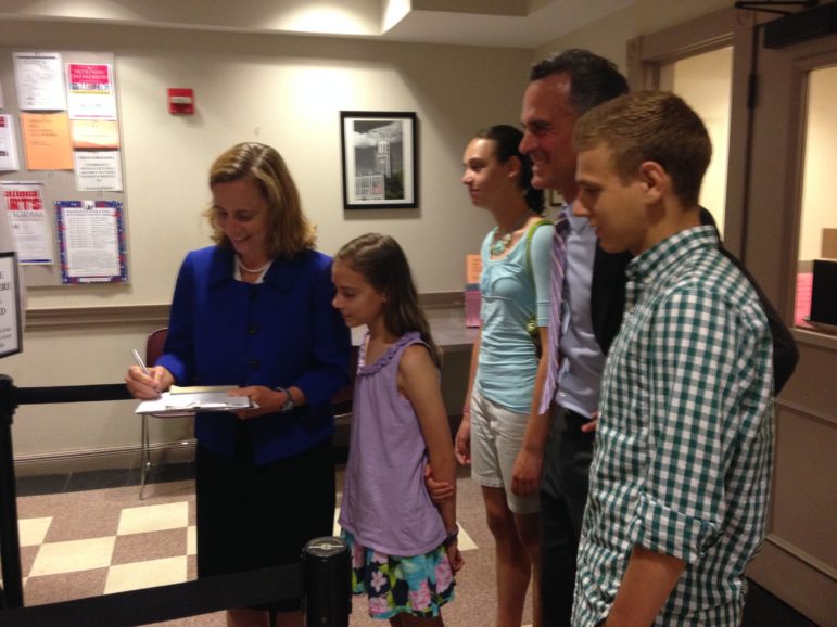 Joyce Craig files paperwork to run for mayor on July 13. She was joined by her husband, Michael, and their three children, William, Sarah, and Kathryn.