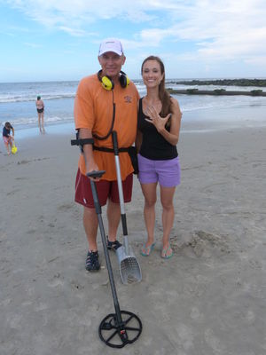 Kristine Carney of New York City stands with Marc Mercier, at left, of Manchester, NH, and shows off her engagement and wedding rings found Aug. 19 by Mercier, who was on vacation with his family.