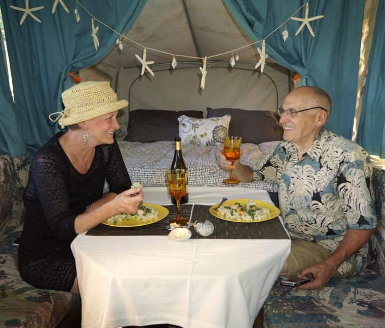 Carolyn and Gordon enjoying dinner in the tiny camper house.