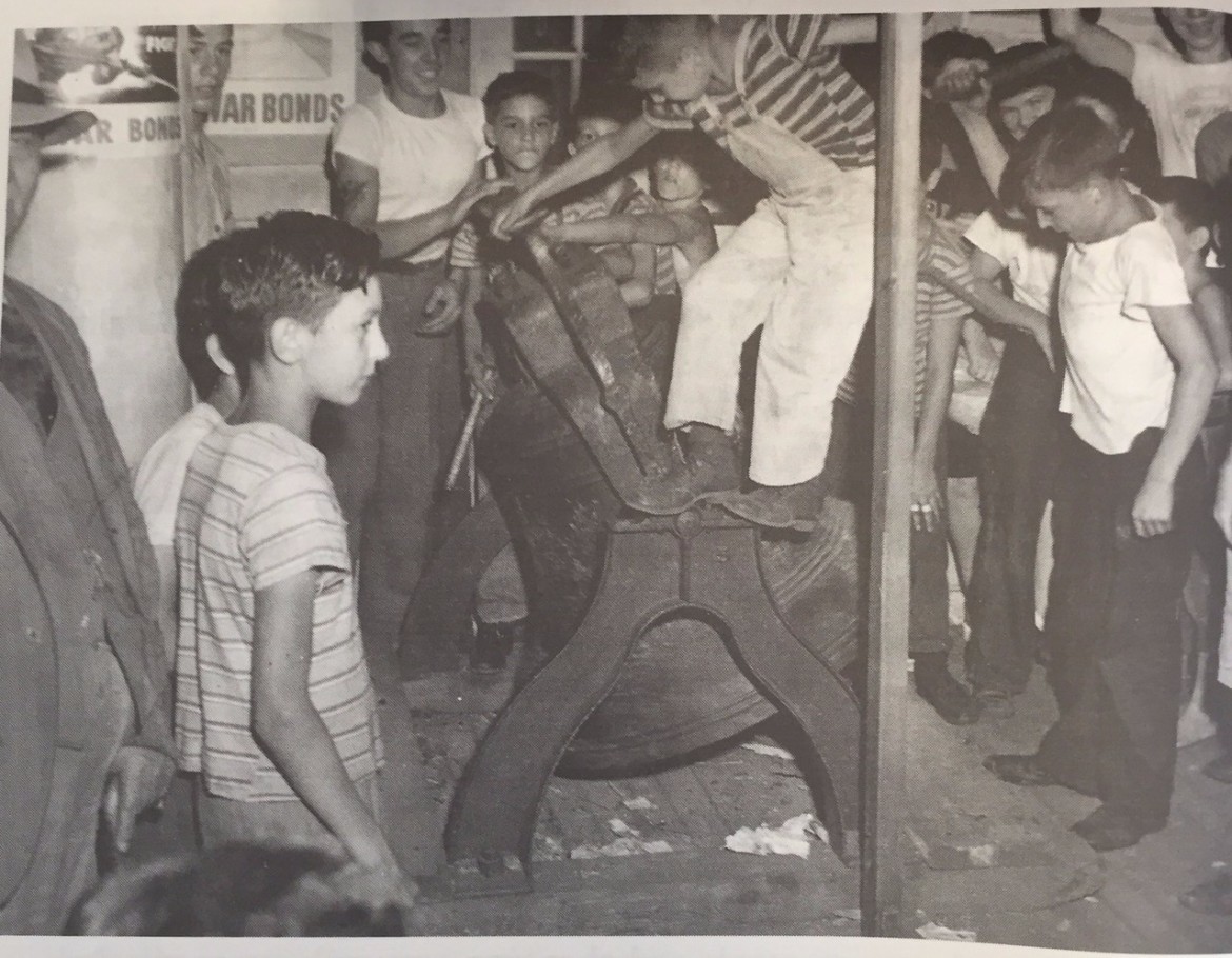 Paper carriers Frank Young, (center), and Emile Bussiere (at right), were the bearers of glad tidings when Manchester erupted in celebration 70 years ago this week.