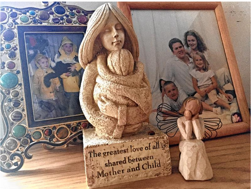 Mementos of motherhood on my mantle.