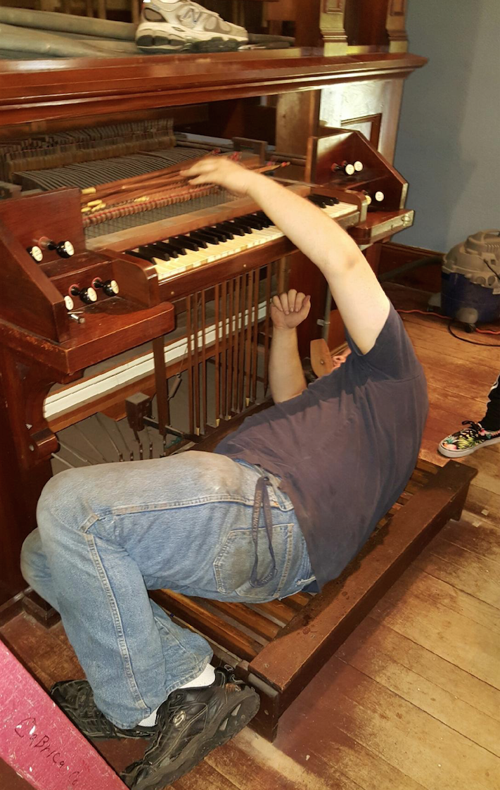 Andover Organ Company organ builder disassembling the organ on Sept. 26 at the church in Byfield, Mass.