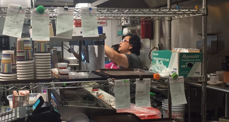 Chan Loi hustles in the kitchen.