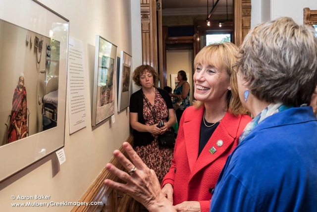 Photographer Becky Field walks Gov. Maggie Hassan through an exhibition of her work during the Sept. 17 book launch.