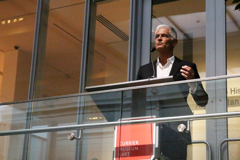 James Nachtwey at the lectern during a preview of his photo exhibition at the Currier Museum.