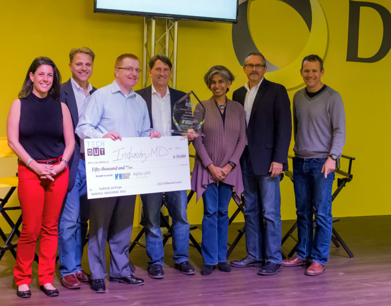 TechOut first-place winner Jim Kelly holds a check for his $50,000 prize. Also pictured from left: Michelline Dufort, Paul Mailhot, Matt Cookson, Toral Cowieson, Mark Kaplan, and Matt Rightmire. 