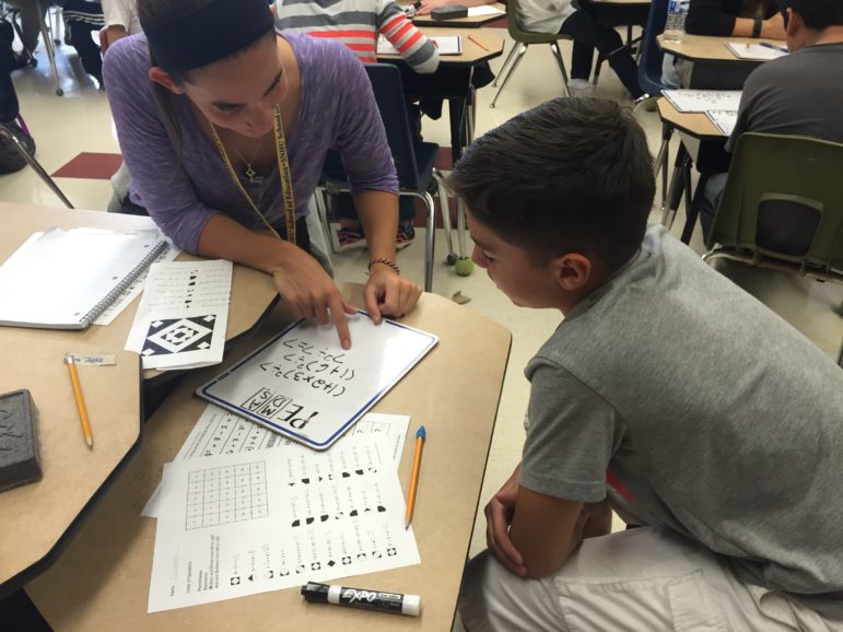 Devan Rabidou, a student-teacher from SNHU, works one-on-one with Giovanni, a Weston Elementary student.