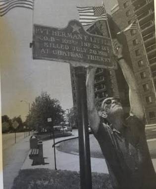 City workers tend to the bronze plaques that occupy places of honors in streets and squares around Manchester, the better to remember those who served.