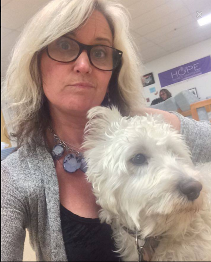 Kriss Blevens with her new temporary sidekick, Curly, a dog abandoned by his owner at Hope for NH Recovery.