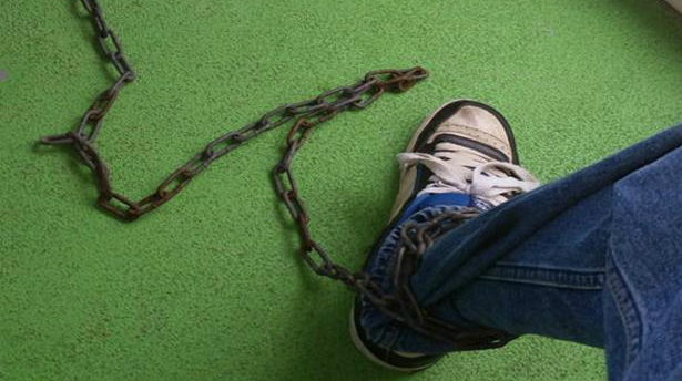 Kevin Dumont's foot chained to the 30-foot slide at Liquid Planet.