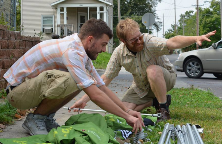 Eric Zulaski, right, of NH, works with Kevin Rutledge at a recent AFSC GUI Hilary Clinton visibility event in Iowa.