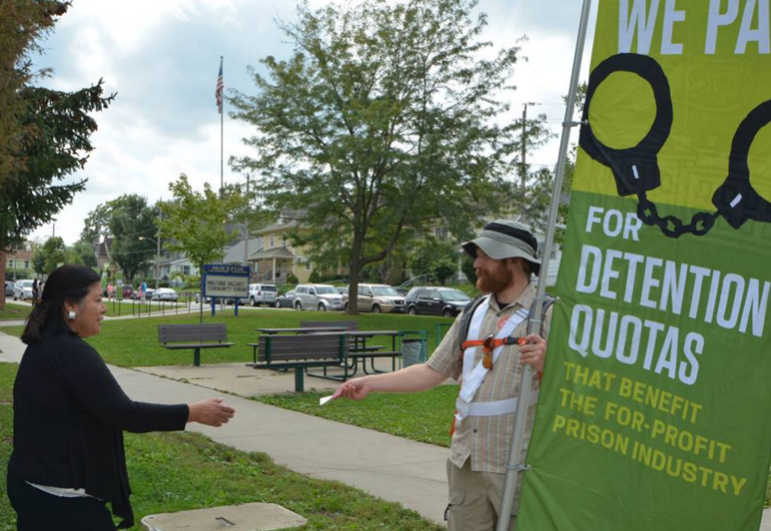 Eric Zulaski, right, of NH, talks to an Iowa voter about the AFSC's issues platform.