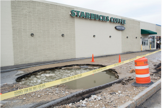 Aftermath of a water main break that created a sink hole at the Starbucks drive-thru on South Willow Street.