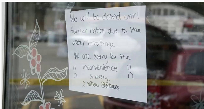 Customers have to get out of their cars to get their Starbucks fix while the hole is repaired.