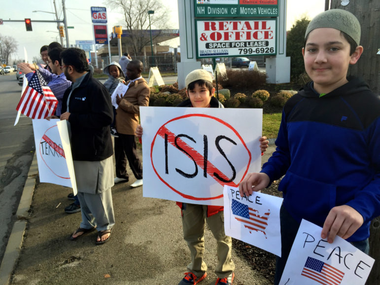 All-American brothers Hassan Khan, center, and his brother Hammad Khan, right, participated in the peace march.