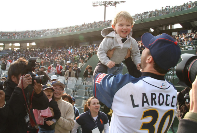 Caden Jax LaRocca gets a lift from his dad as fans snap photos.