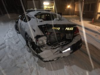 State Police cruiser mangled by hit-and-run trucker with Canadian plates.
