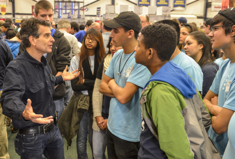 FIRST® Founder Dean Kamen and FIRST Robotics Competition Team 1289, “Gearheadz” from Lawrence, Mass., talk excitedly at the Kickoff event in Manchester, New Hampshire – where more than 1,000 attendees gathered for the 2016 game reveal of FIRST STRONGHOLDSM. 