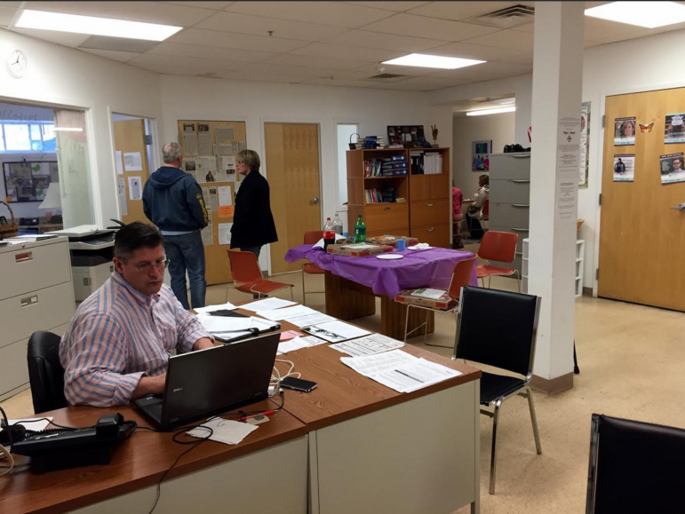 Dana Lemire, left, mans the desk inside Hope for NH Recovery's temporary home at 140 Central St.