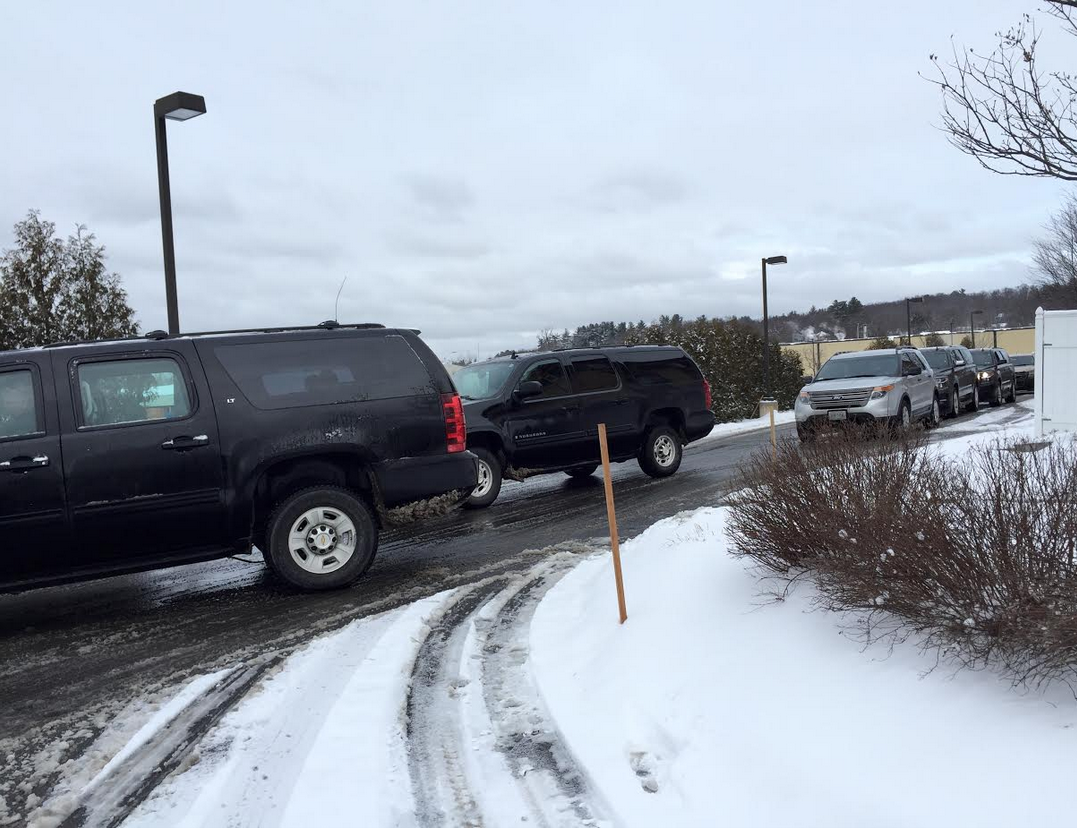 An entourage waits outside of the Airport Diner, reportedly for Donald Trump, who was one of the candidates lining up for a live interview via FOX & Friends.
