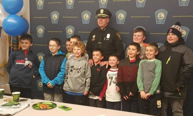 Chief Willard poses with his new BFFs at Zack Telge's 9th birthday party.