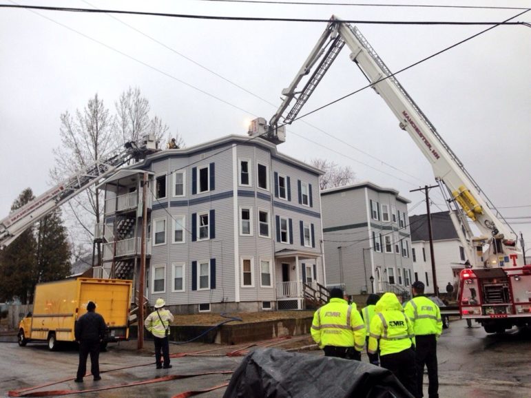 Crews attack a ceiling fire at a Belmont Street apartment on Friday.