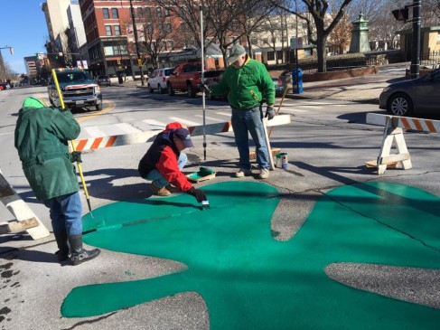 Annual painting o' the green on Elm Street.