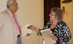 InDepthNH.org founder Nancy West speaks with state Rep. Ben Baroody at the statehouse in Concord.