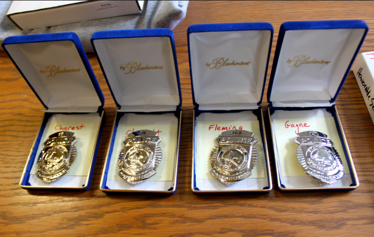 Badges ready for new officers from a previous Manchester Police swearing in ceremony.