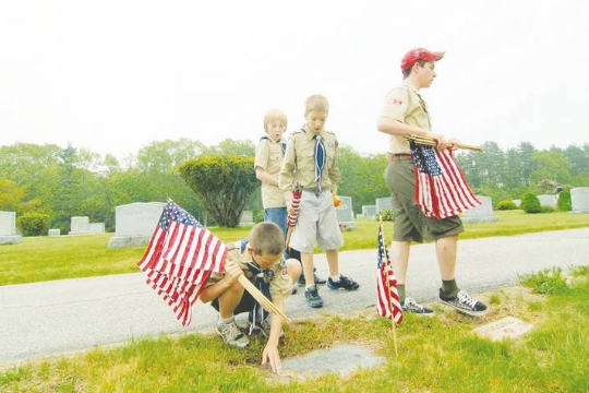 Scouts decorating a graveyard in Derry, NH.